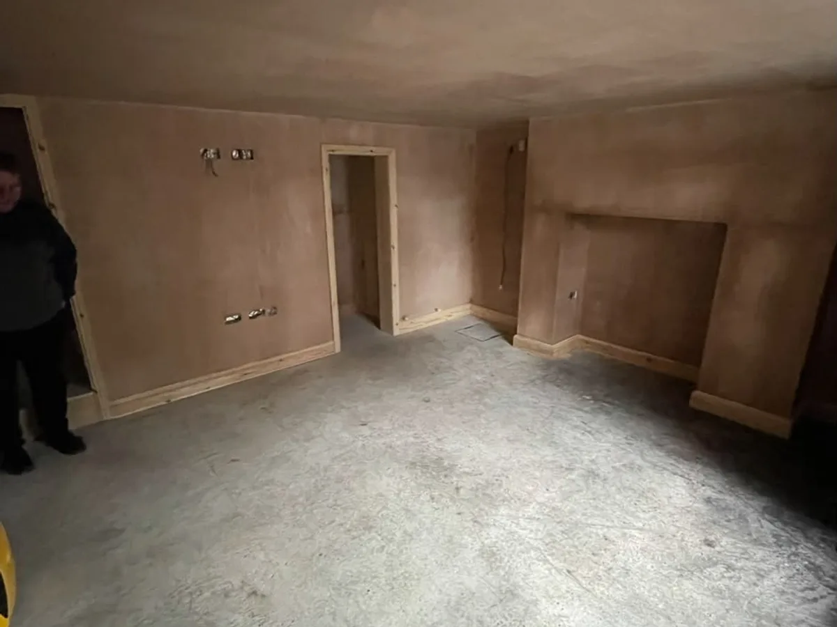 Wakefield cellar room replastered to a flat, paint-ready finish with a clean doorway opening