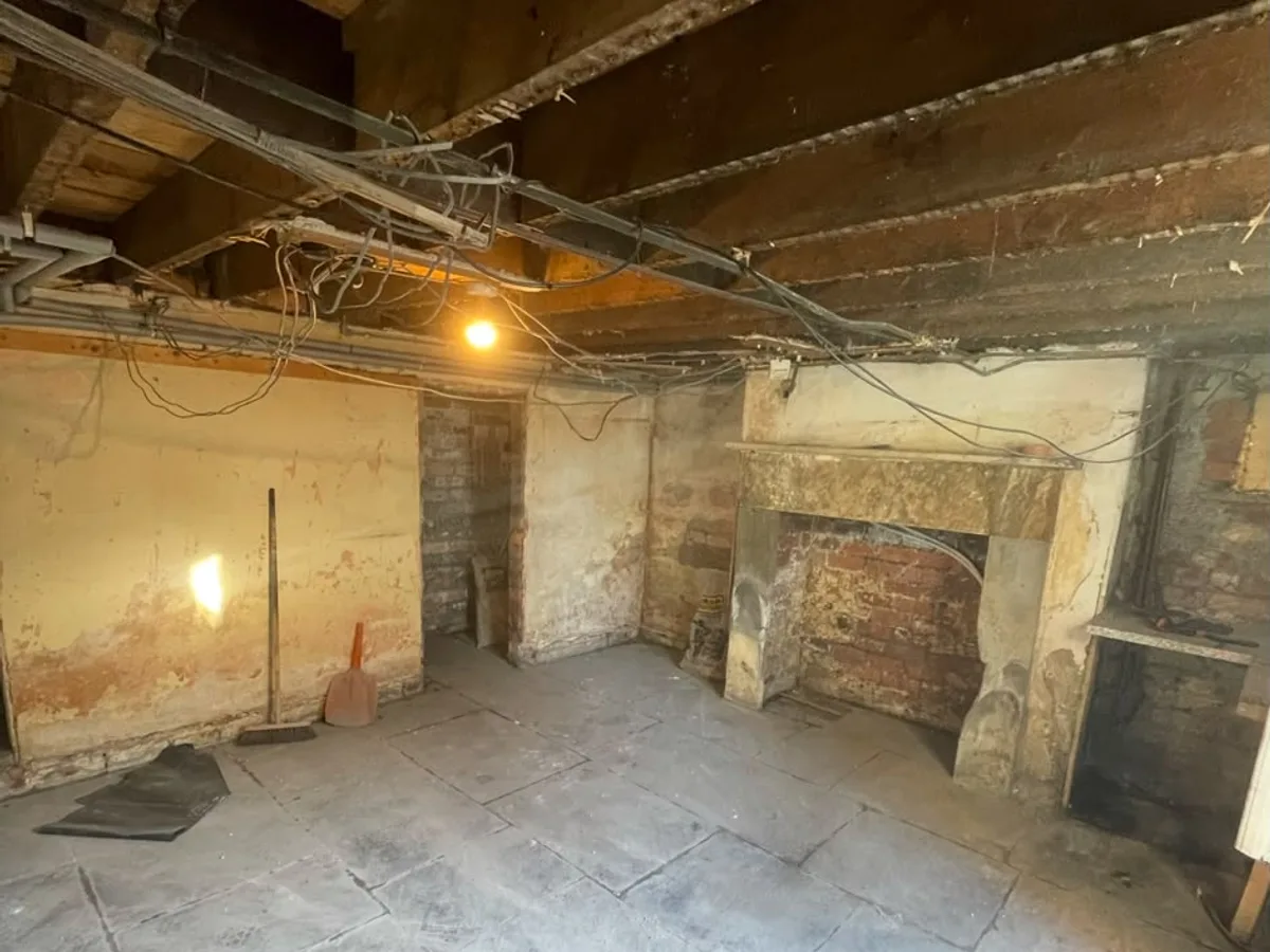Wakefield cellar stripped back to bare stone with an original fireplace and exposed ceiling joists